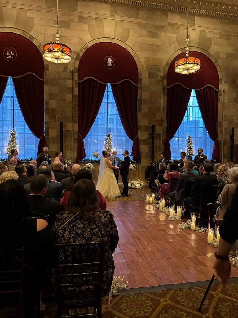 Couple at the altar in a grand winter ballroom