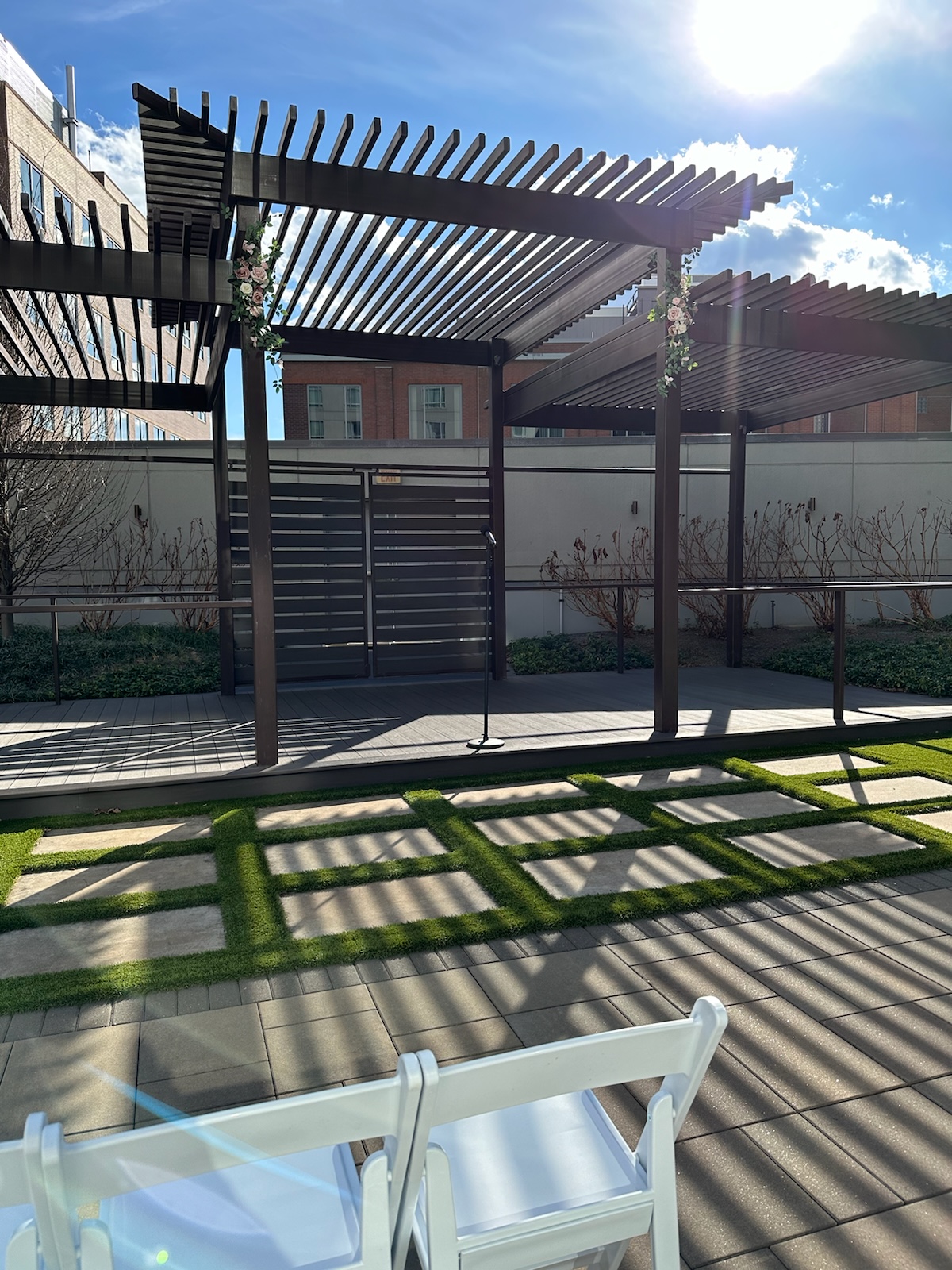 Modern outdoor pergola ceremony space with floral accents